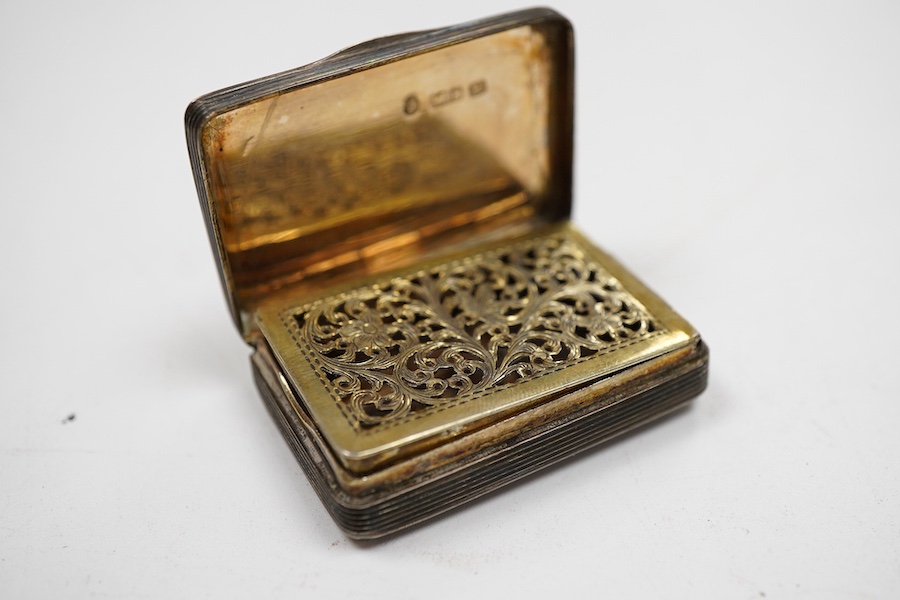 An early Victorian silver rectangular vinaigrette, with engraved chequered decoration, by William Simpson. Birmingham, 1836, 39mm, together with a late Victorian silver vesta case.